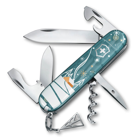 A Swiss army knife with a light ice blue and transparent scale design featuring winter motifs, extended tools including blade, large blade, corkscrew, and more.
