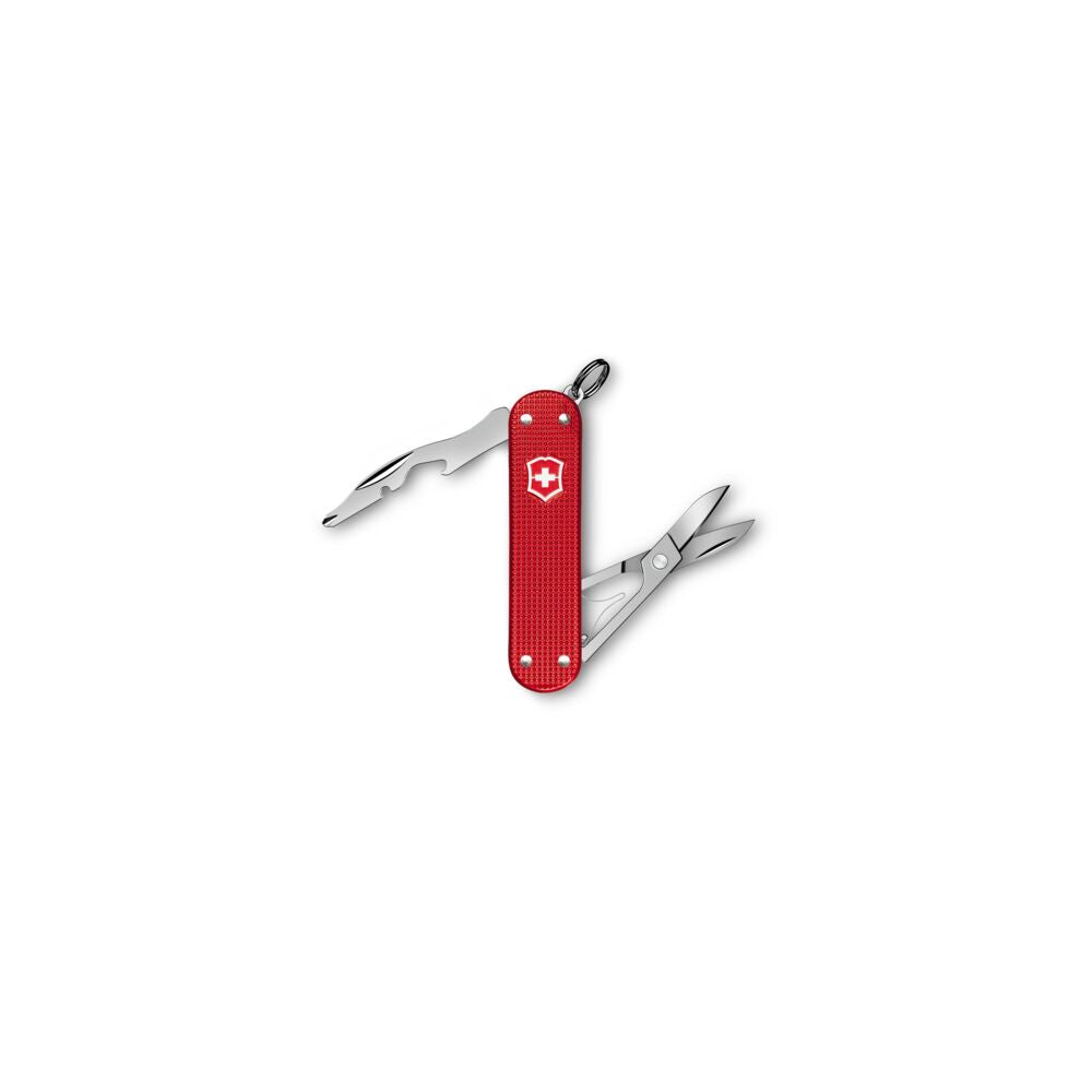 Red Swiss Army knife with tools on a white background