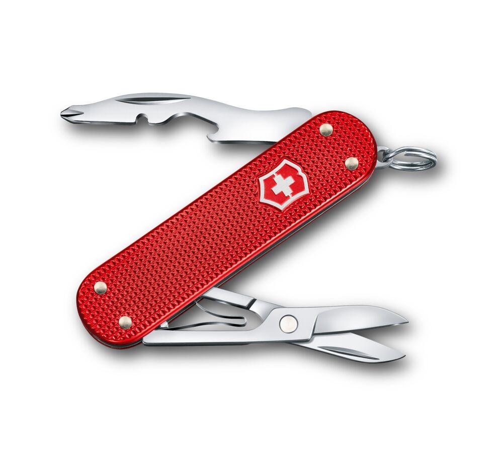 Red Swiss Army knife with silver tools on a white background