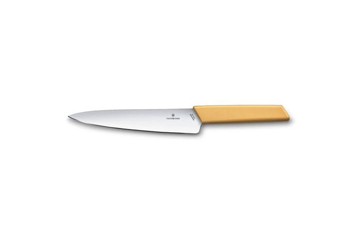 Carving knife with silver blade and honey-colored handle, side view