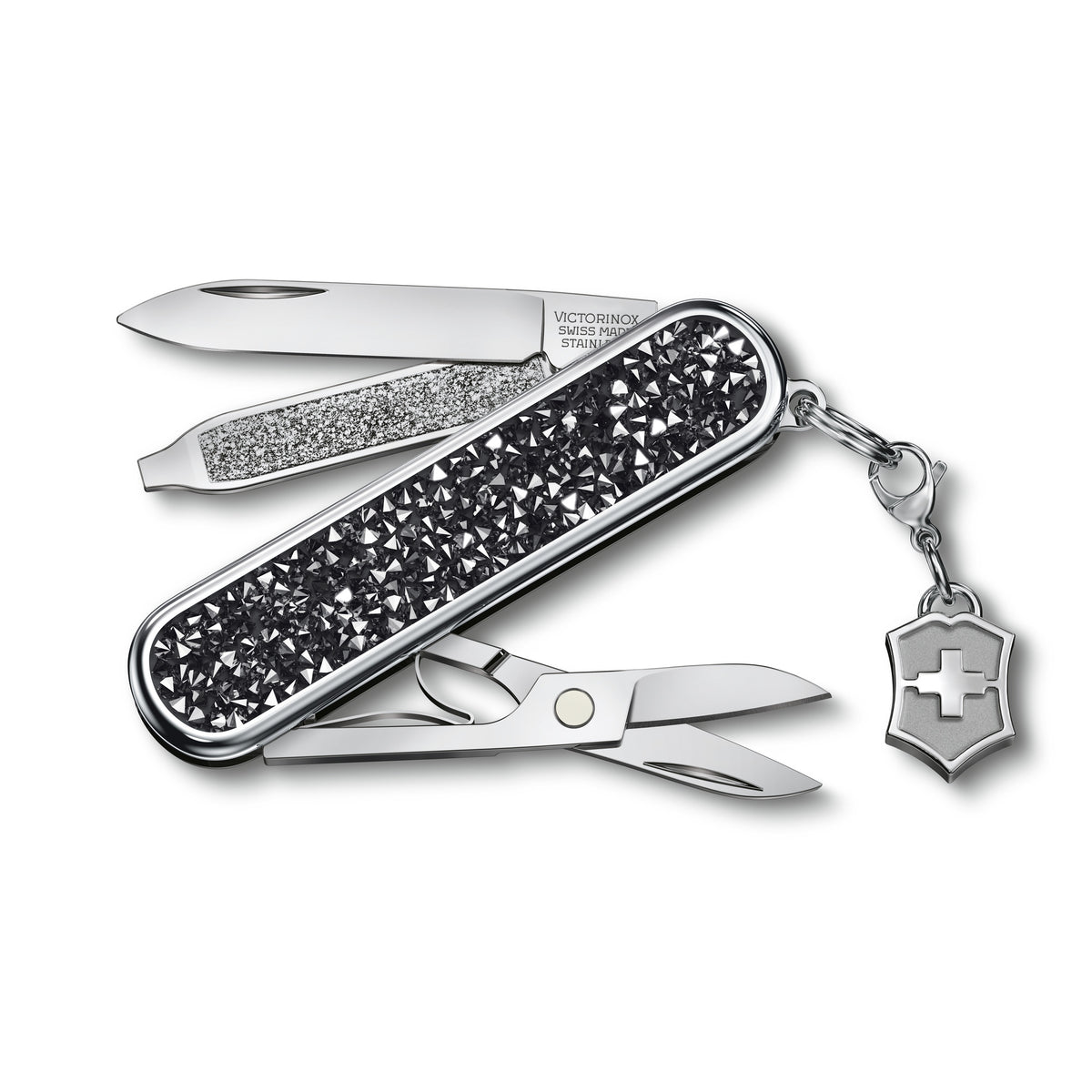 Opened keychain multi-tool with black crystal scales, blades extended, shield charm