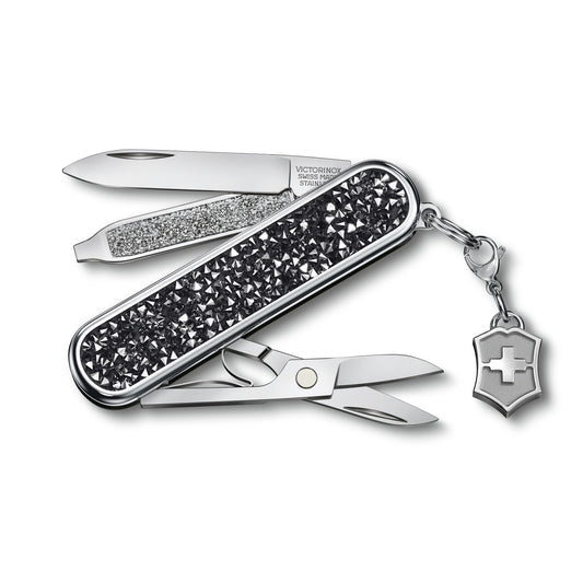 Opened keychain multi-tool with black crystal scales, blades extended, shield charm
