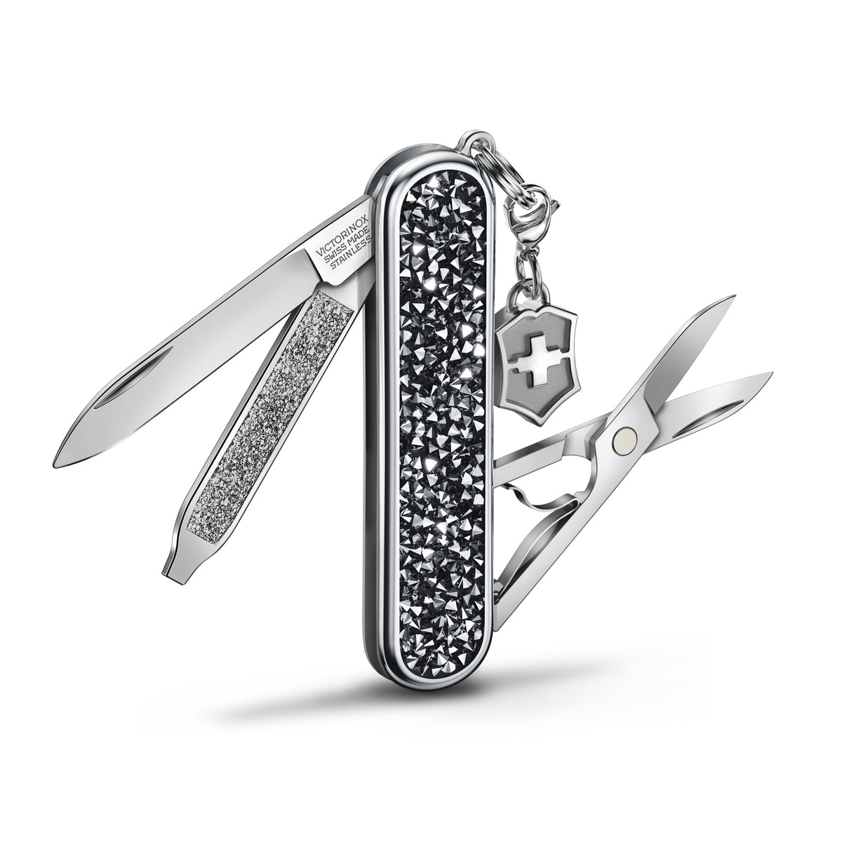 Opened multi-tool on keyring with black crystal handle and metal cross shield charm