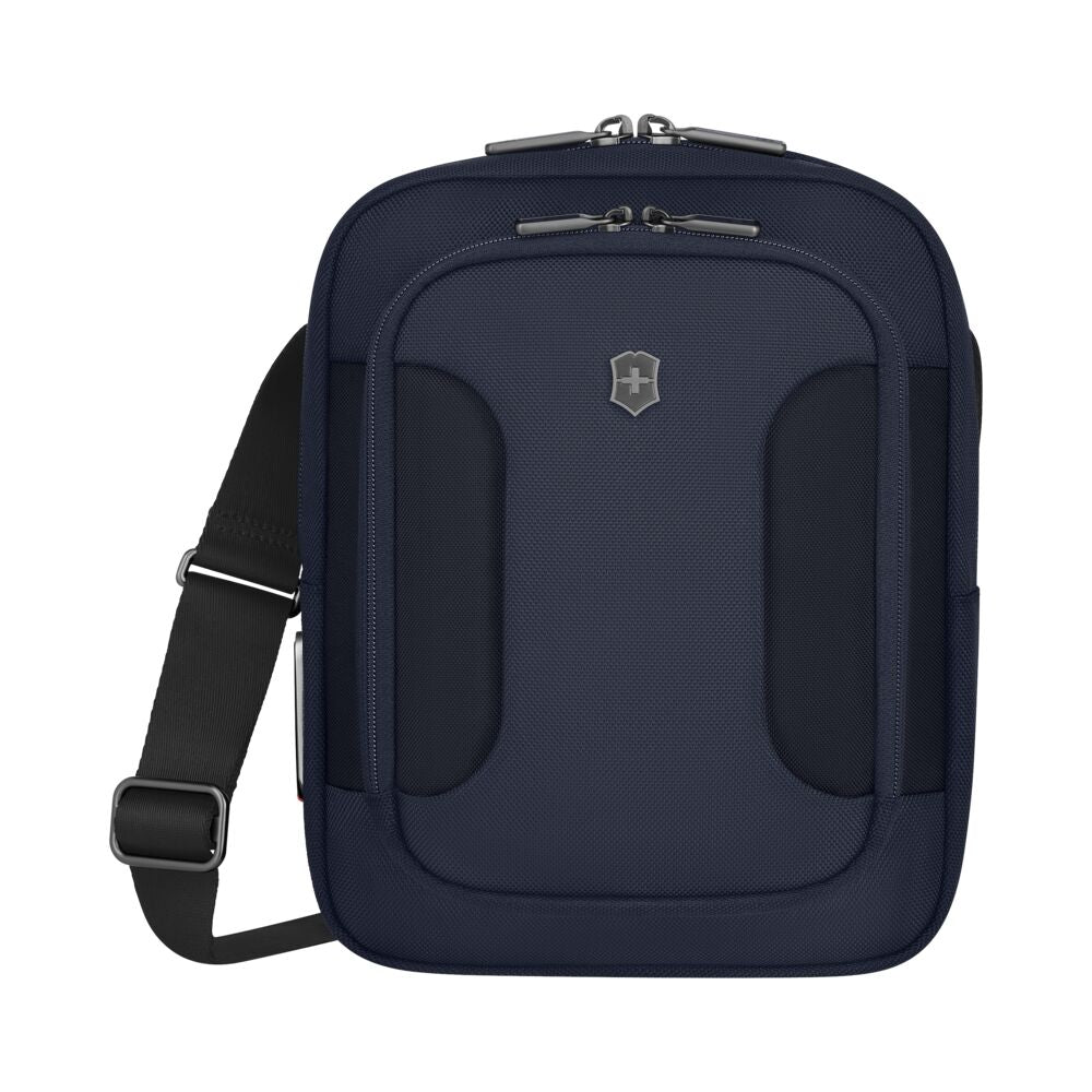 Blue crossbody bag with front emblem, dual zipper pockets, and adjustable shoulder strap