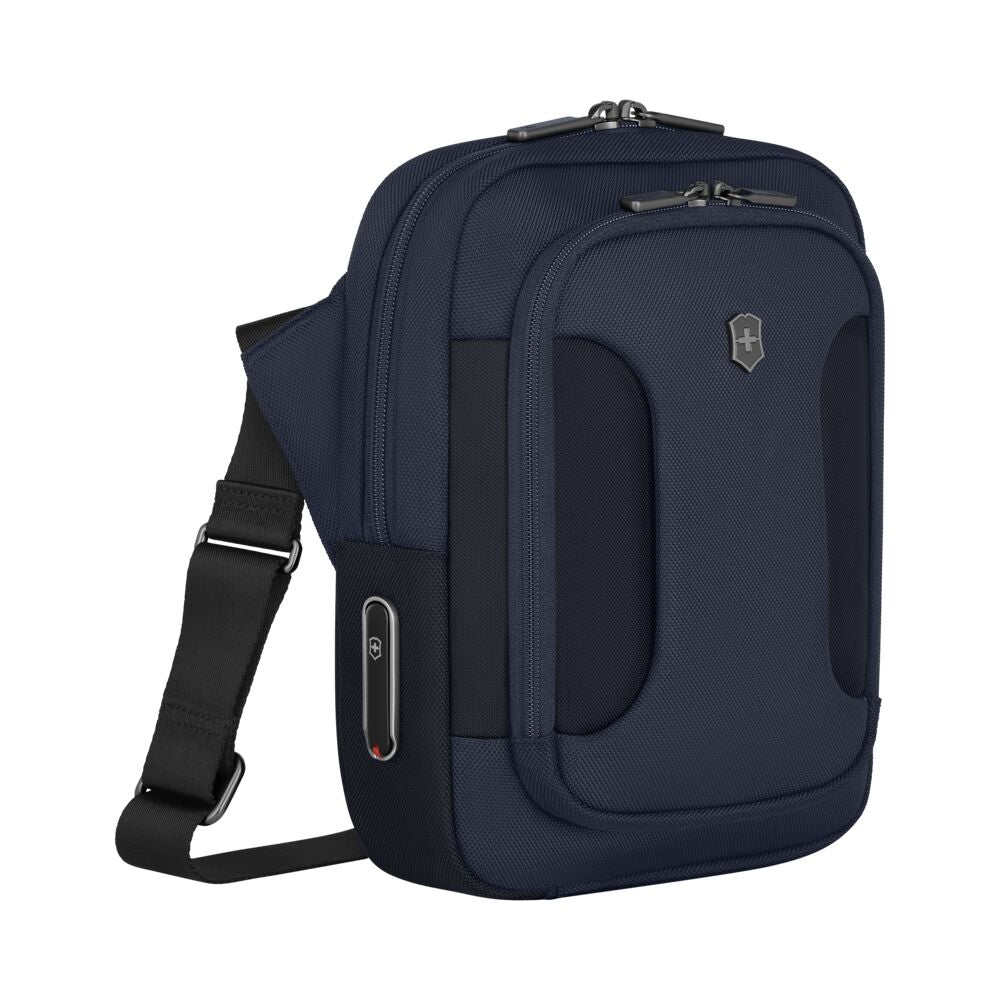 Blue crossbody bag with front cushioned pockets, shield emblem, and shoulder strap