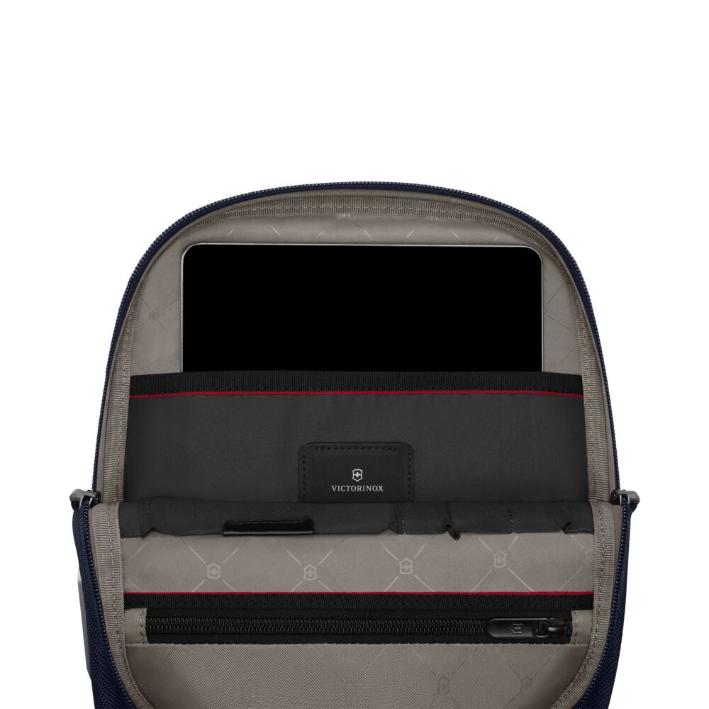 Blue crossbody bag interior view with gray lining, central organizer, and red trim