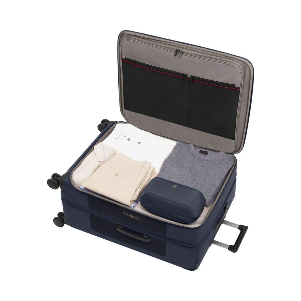 Blue open suitcase interior with folded clothes and front organizer panel