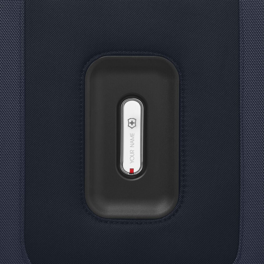 Suitcase front pocket panel with luggage icon label on dark fabric