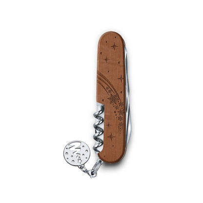 Wooden corkscrew with engraved design on a white background