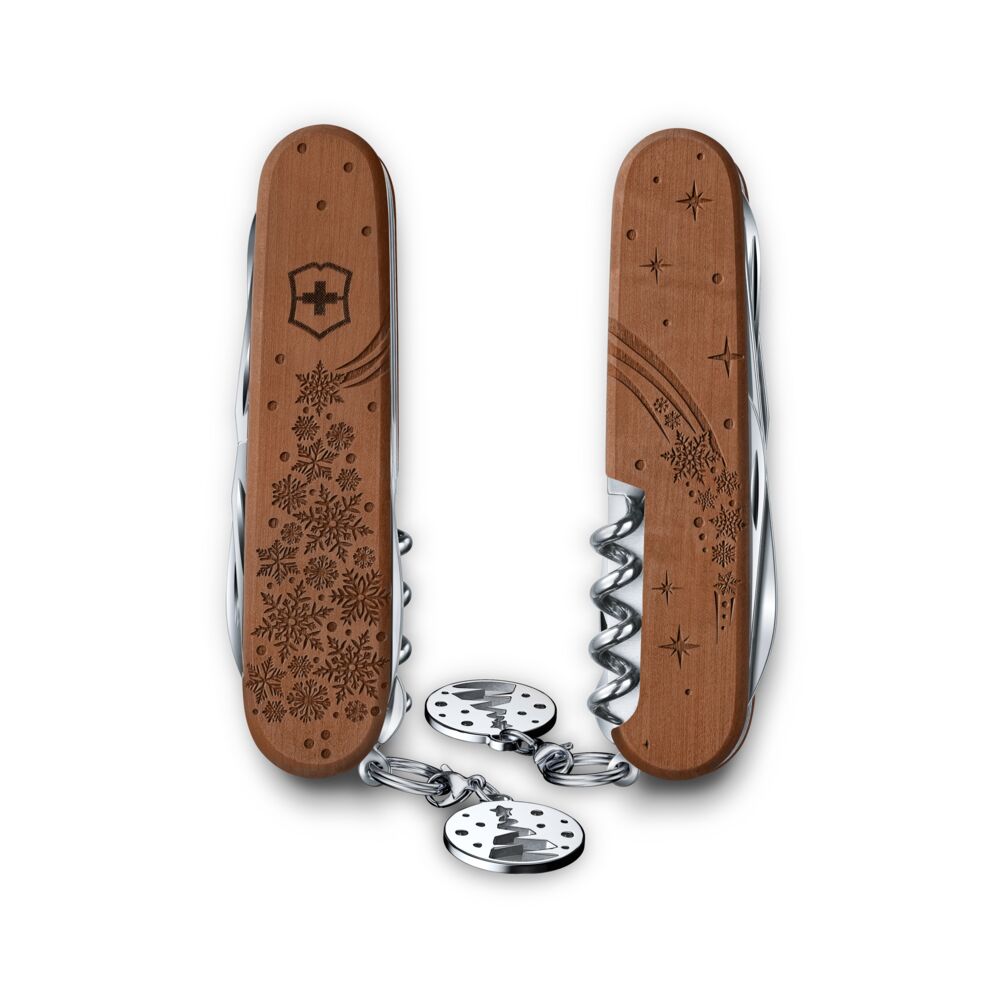 Wooden pocket knife with engraved design and metal chain on a white background