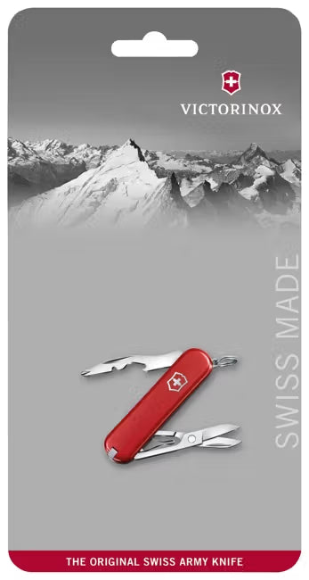 Red Swiss Army knife on a gray card with mountain design and Victorinox branding